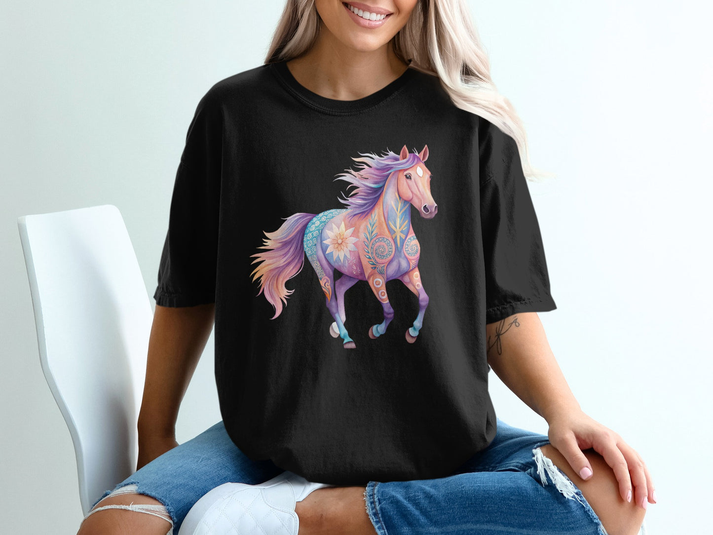 Black t-shirt with a colorful, floral-patterned horse graphic.