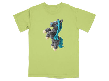 Crocheted gray horse with blue mane and tail on a light green t-shirt.