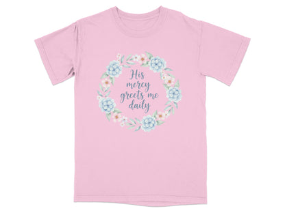 Pink t-shirt with floral wreath and text "His mercy greets me daily".