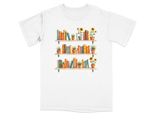 T-shirt with a watercolor illustration of three bookshelves filled with books and potted plants.