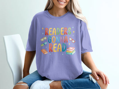 Purple t-shirt with "Readers Gonna Read" in colorful letters and book illustrations.