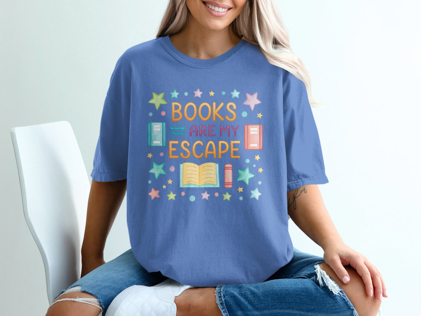 Blue t-shirt with colorful text "BOOKS ARE MY ESCAPE" and book illustrations.