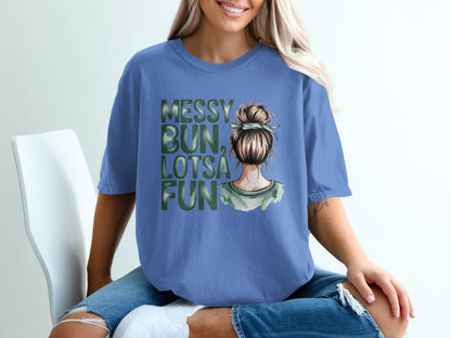 Blue t-shirt with messy bun, lotsa fun text and watercolor graphic.