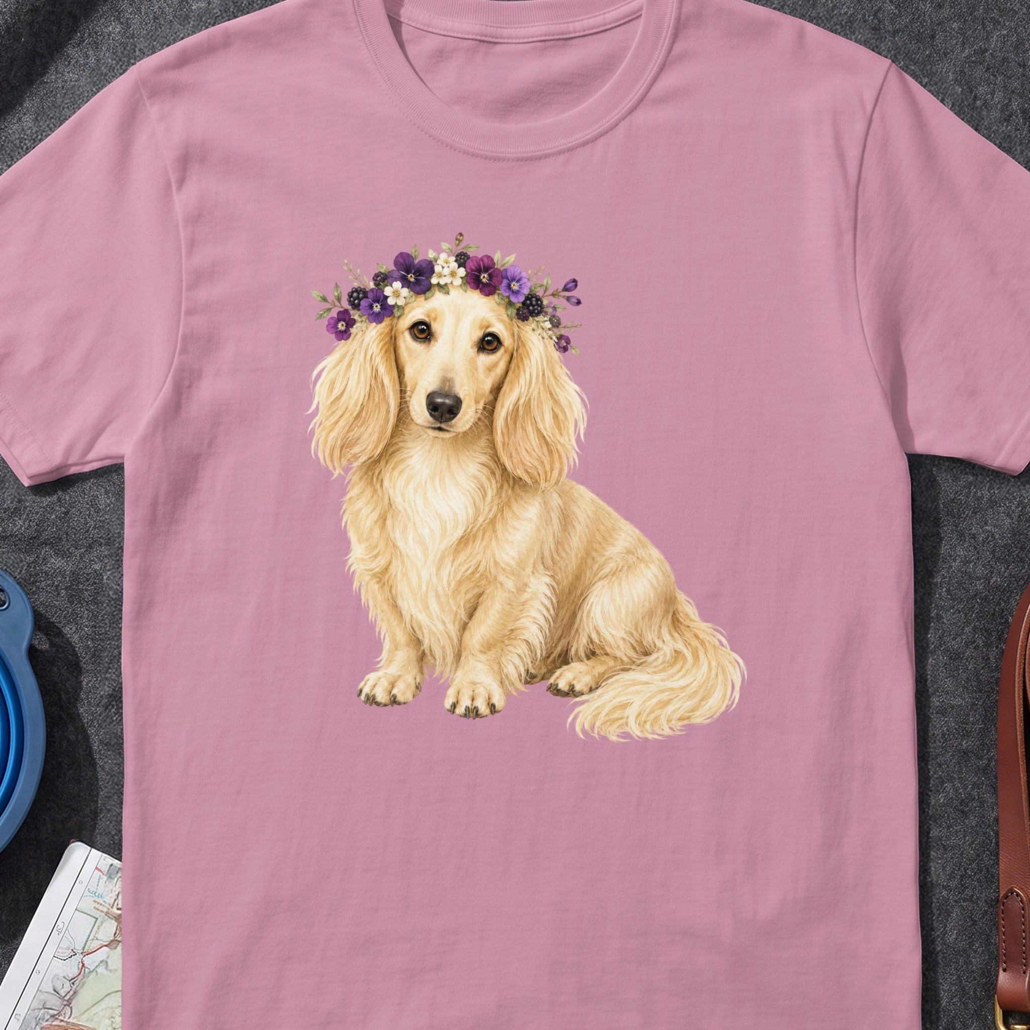 Dachshund wearing a floral crown on a pink t-shirt.