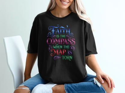Black t-shirt with colorful text: "Faith is the compass when the map is torn."