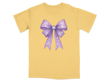 Purple watercolor bow with clear rhinestones on a yellow t-shirt.