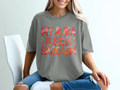 Grey t-shirt with "MY AURA IS 80% SARCASTIC" text in orange and pink.