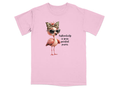 Pink t-shirt with flamingo wearing sunglasses and leopard print bow, text "Authenticity is your greatest power".
