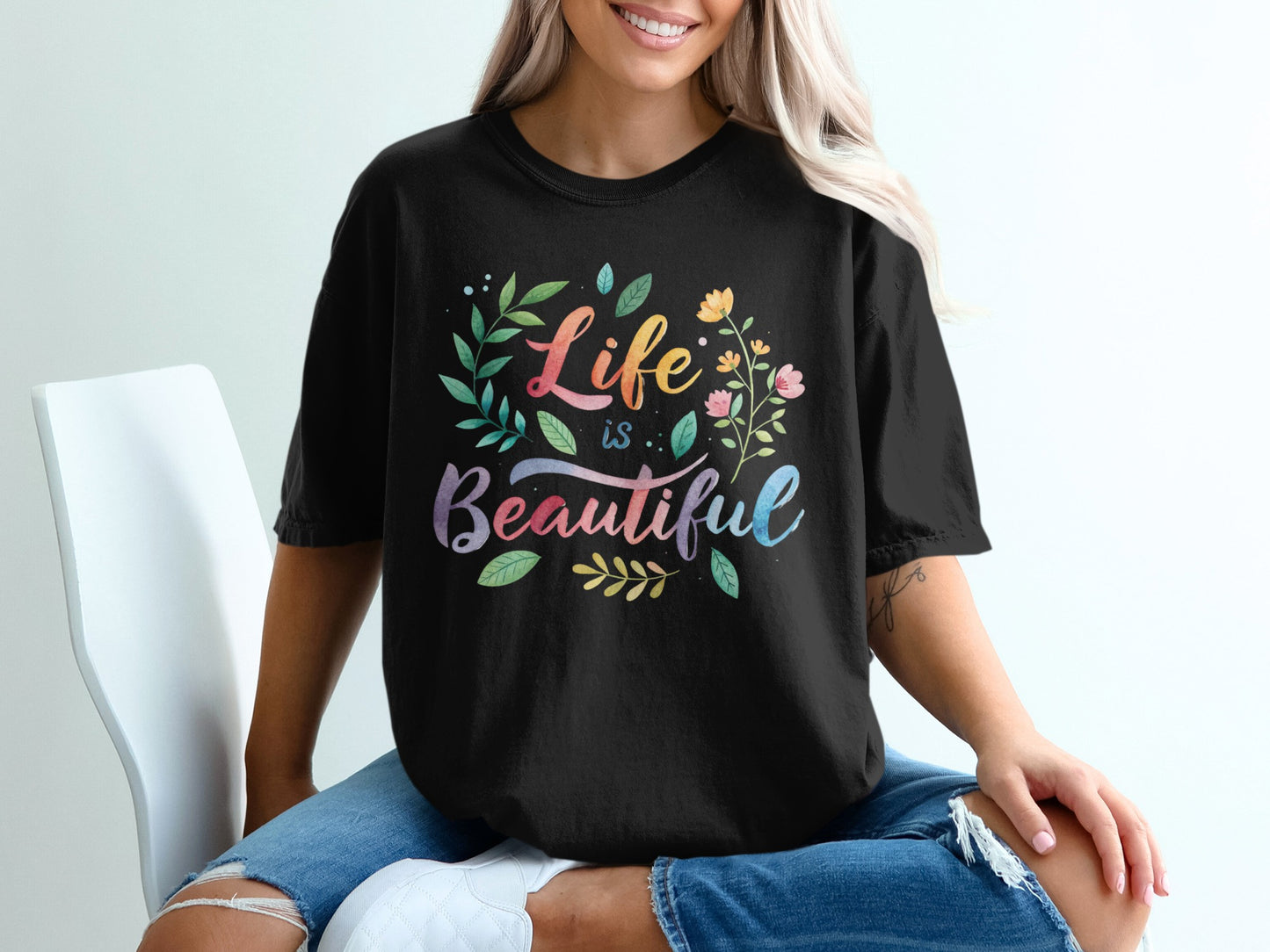 Black t-shirt with colorful "Life is Beautiful" floral text design.