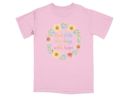 Pink t-shirt with floral wreath and text "God fills my days with hope".