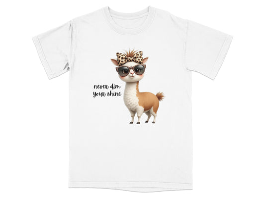 T-shirt with a cartoon llama wearing sunglasses and a bow, text says "never dim your shine".