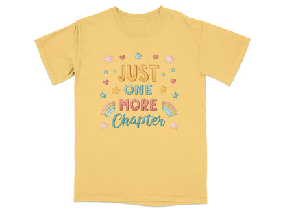Yellow t-shirt with "JUST ONE MORE CHAPTER" text and colorful stars.