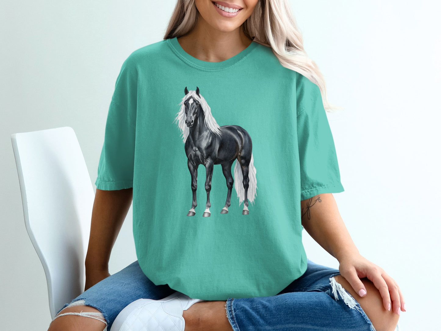 Black horse with white mane and tail on teal t-shirt.