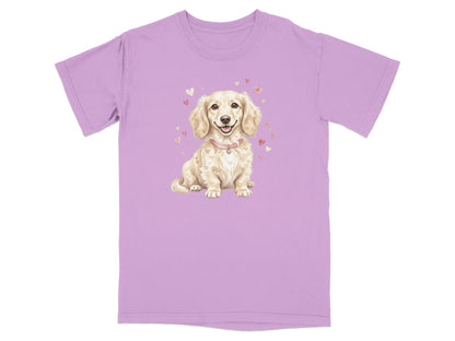 Cream-colored dachshund with hearts on a light purple t-shirt.