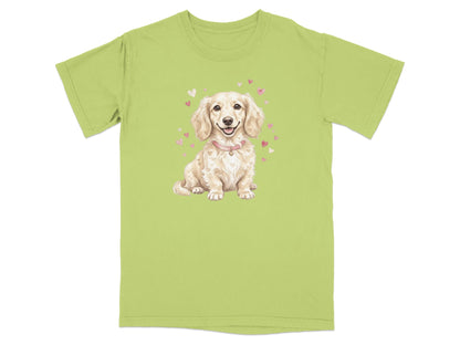 Light green t-shirt with a cartoon dachshund wearing a pink collar surrounded by hearts.