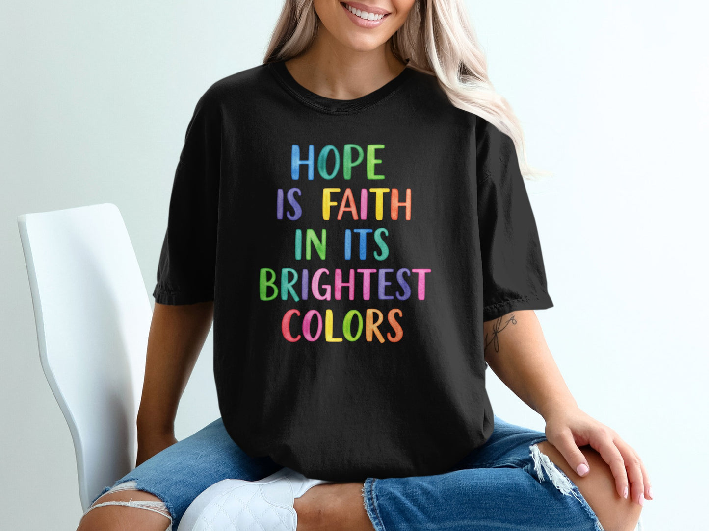 Black t-shirt with colorful text reading "HOPE IS FAITH IN ITS BRIGHTEST COLORS".