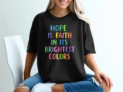 Black t-shirt with colorful text reading "HOPE IS FAITH IN ITS BRIGHTEST COLORS".