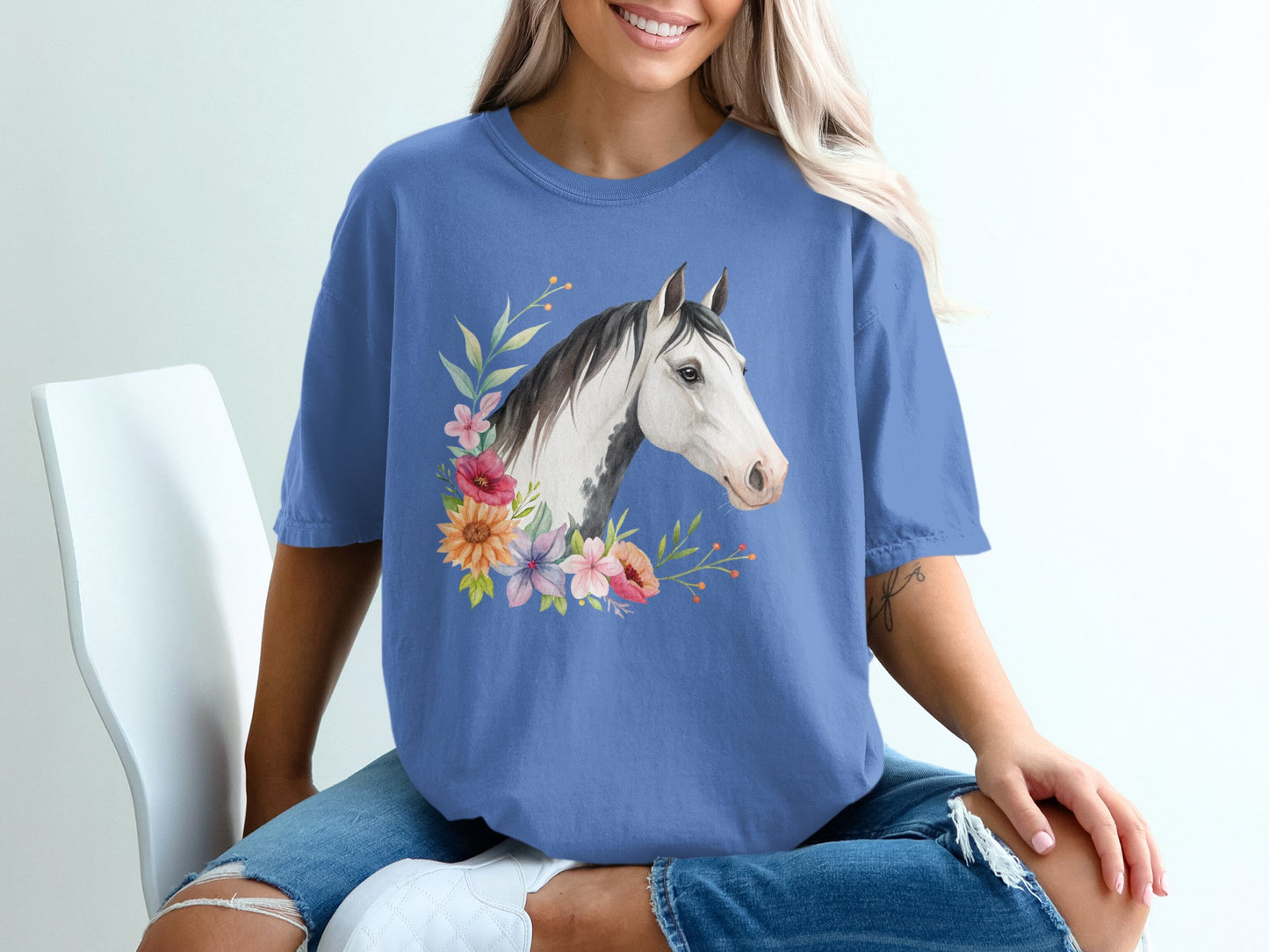 Blue t-shirt with watercolor horse head and floral wreath graphic.