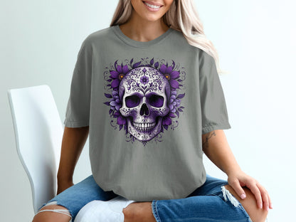 Purple floral skull design on a gray t-shirt worn by a woman.