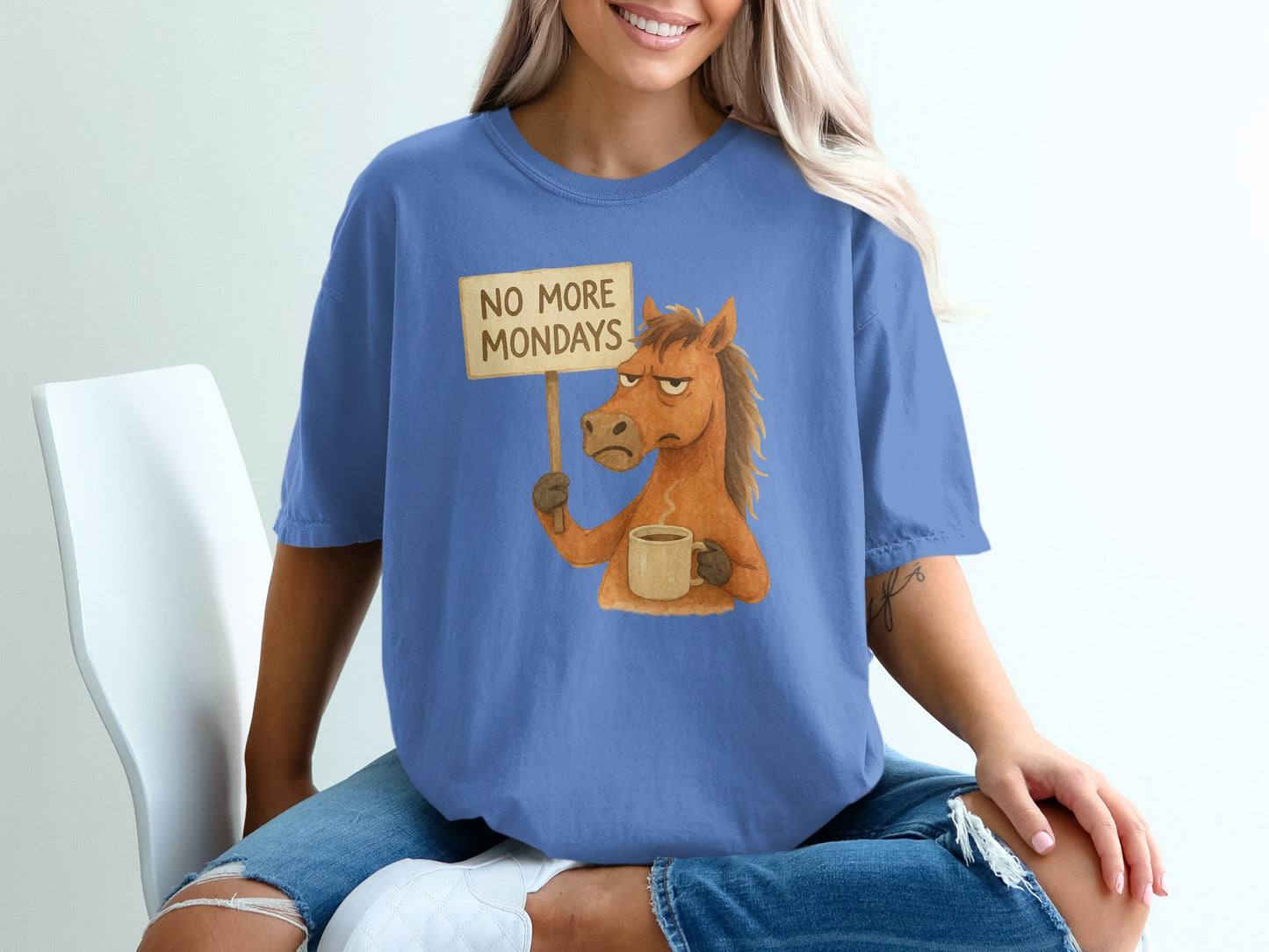 Horse wearing a t-shirt, holding a "No More Mondays" sign and a coffee cup.