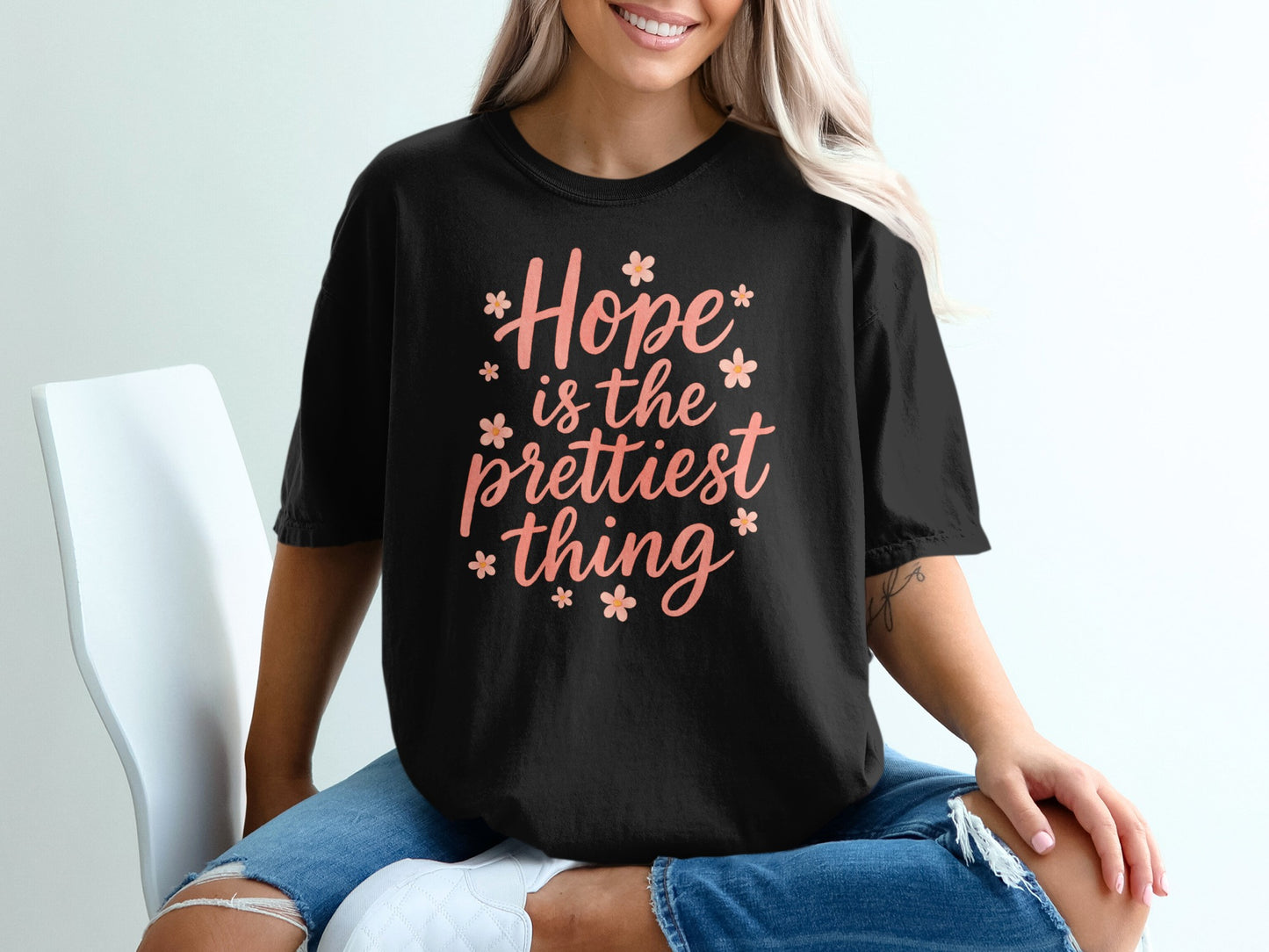 Black t-shirt with "Hope is the prettiest thing" text and floral accents.