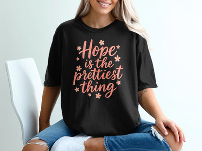 Black t-shirt with "Hope is the prettiest thing" text and floral accents.