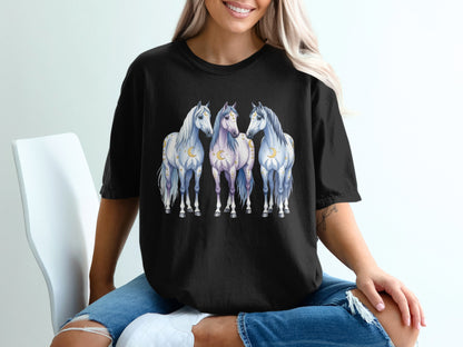 Black t-shirt with three white and grey horses adorned with moons and stars.