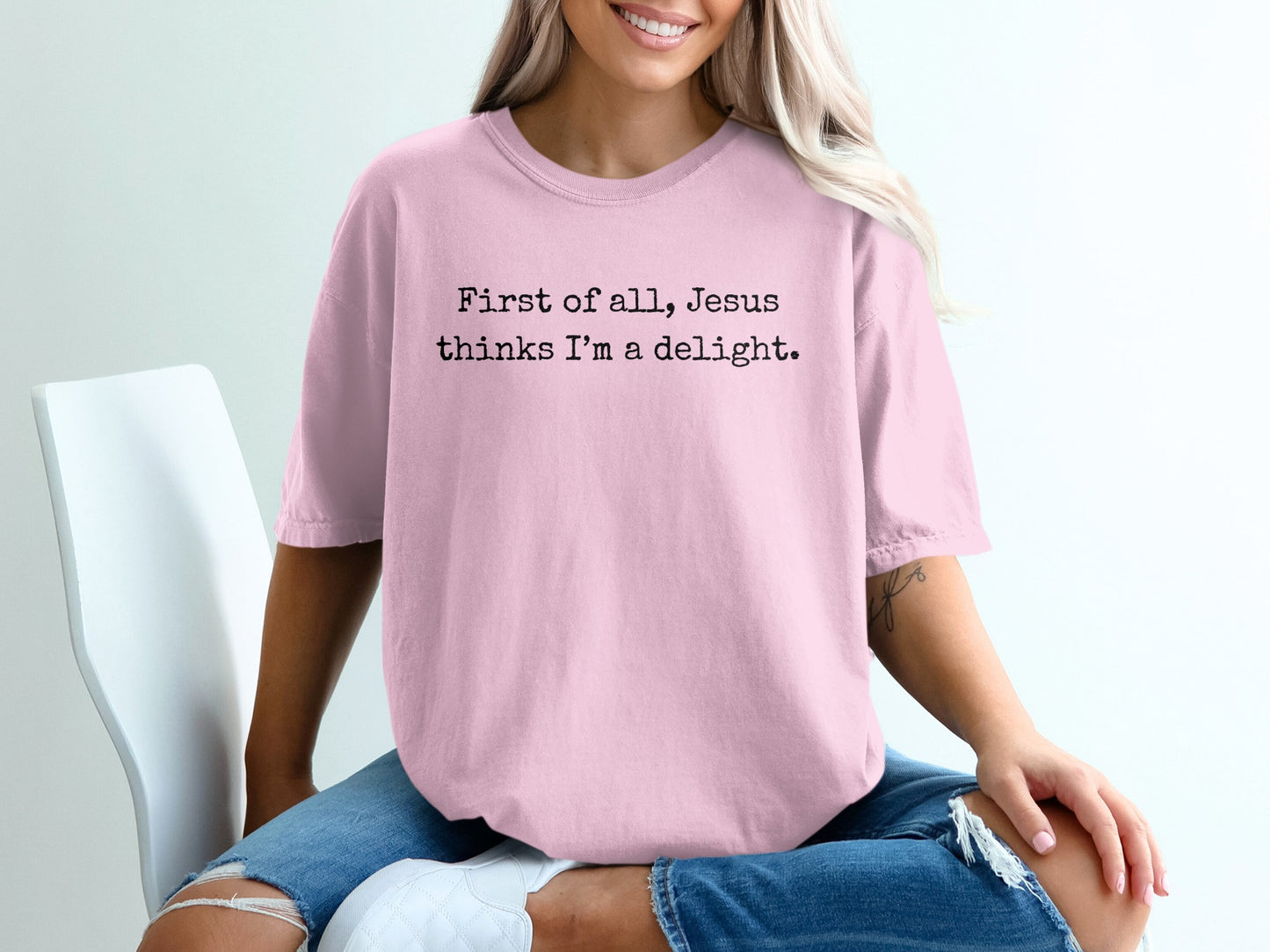 Pink t-shirt with text "First of all, Jesus thinks I'm a delight."