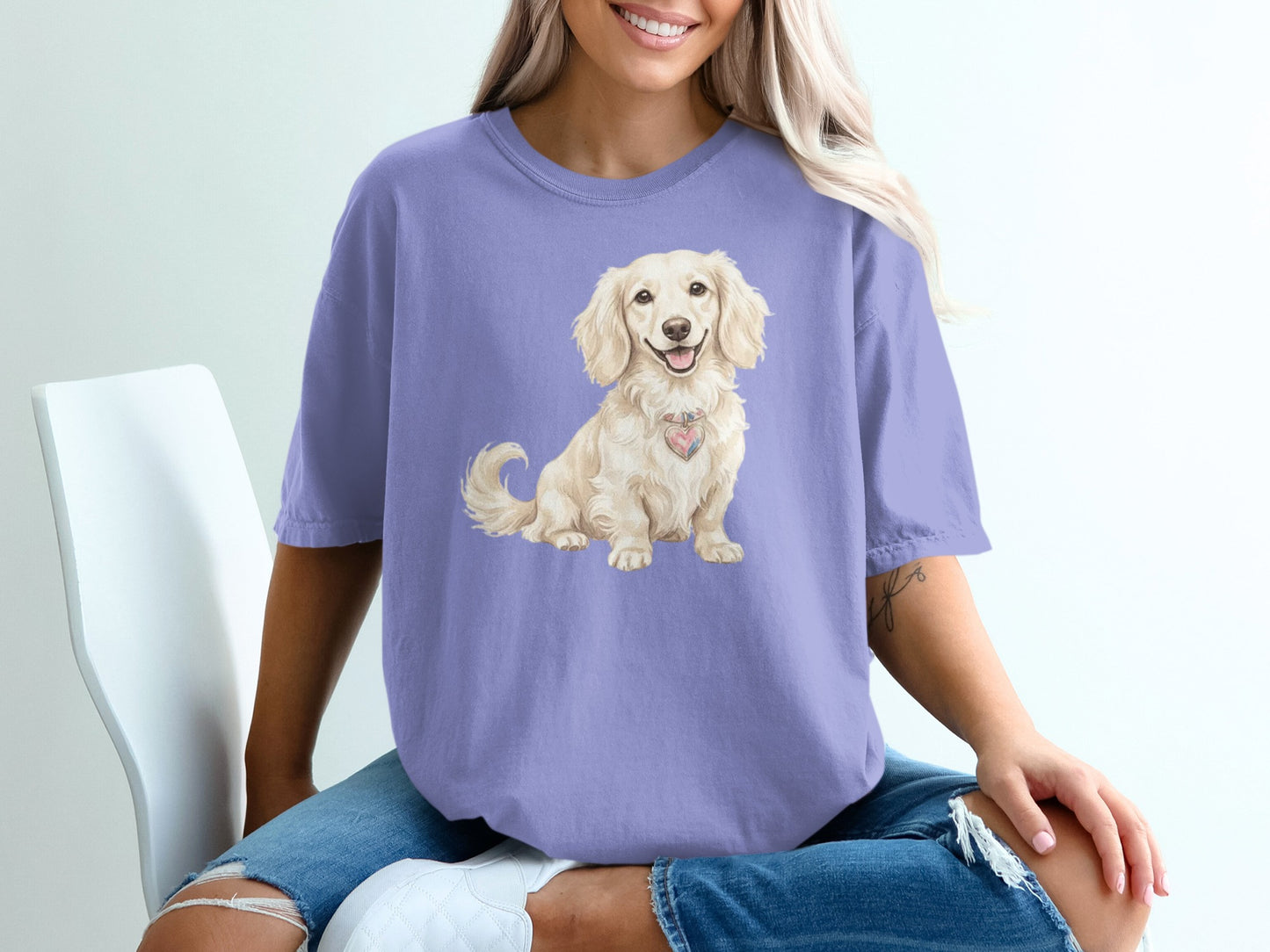 Woman wearing purple t-shirt with light-colored dog graphic.