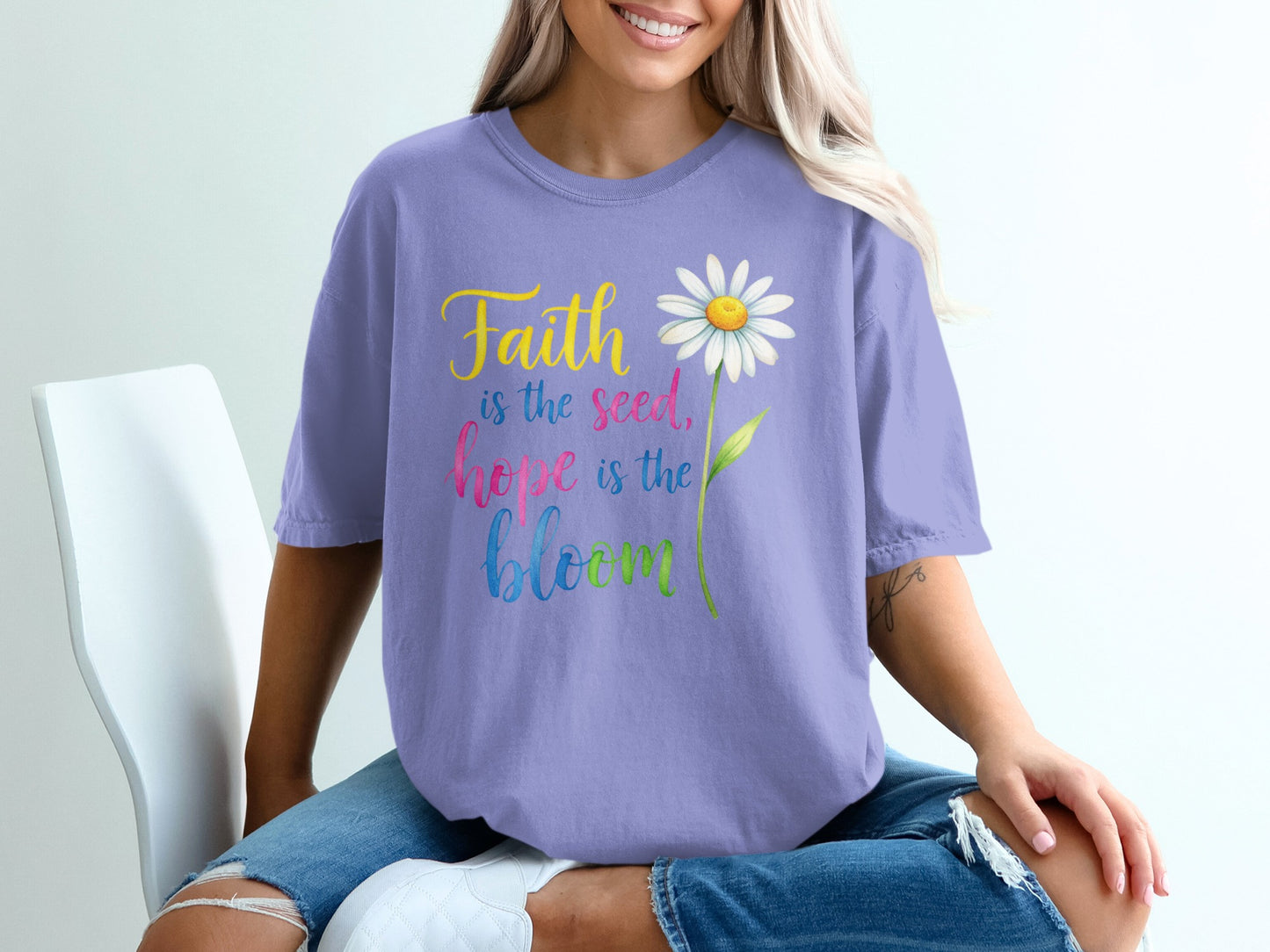 Purple t-shirt with "Faith is the seed, hope is the bloom" and a daisy.
