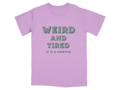 Purple t-shirt with "WEIRD AND TIRED IT IS A LIFESTYLE" text.