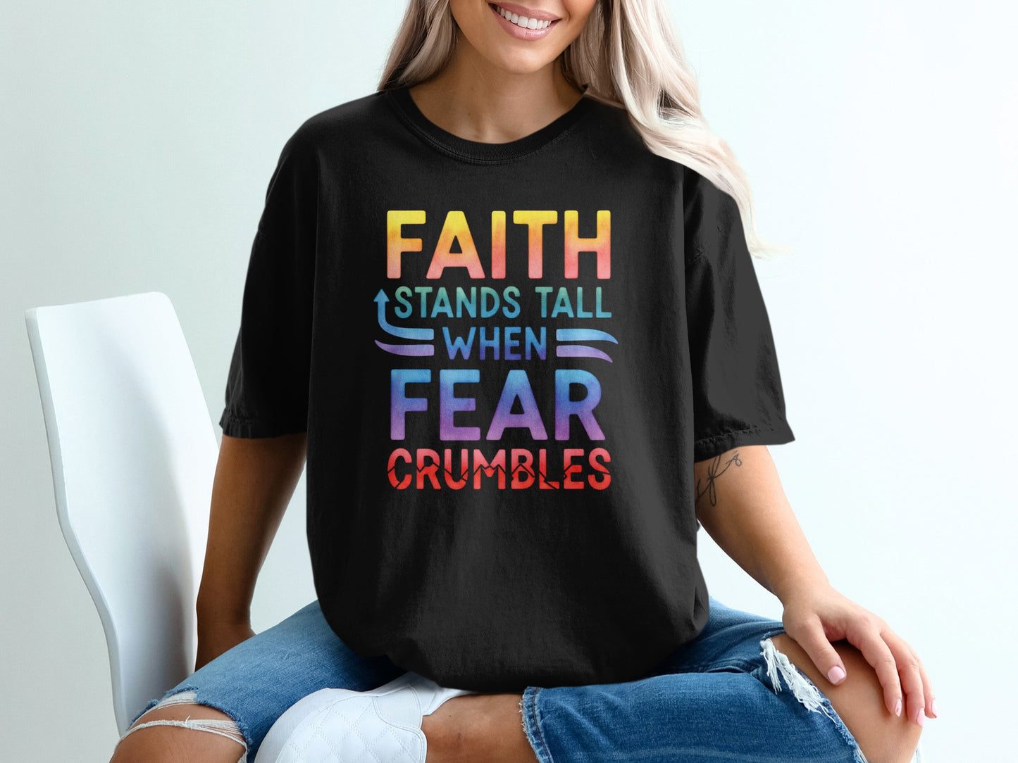 Black t-shirt with colorful text: "FAITH STANDS TALL WHEN FEAR CRUMBLES".