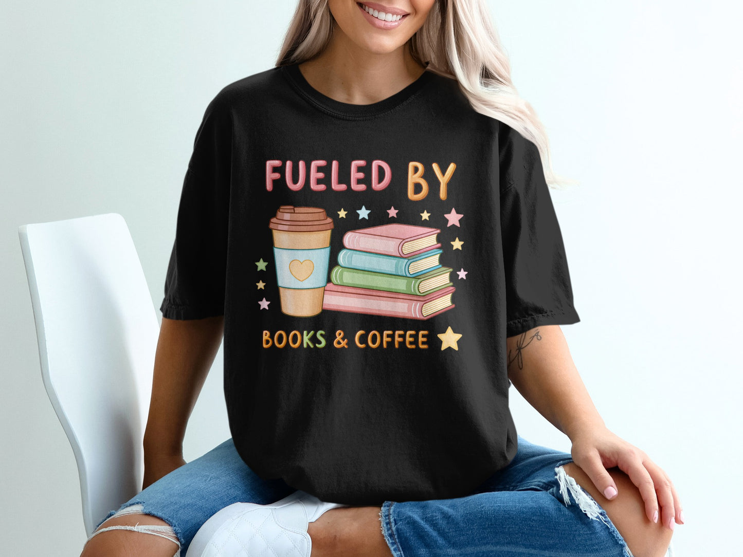 Black t-shirt with "Fueled by Books & Coffee" text and stacked books and coffee cup graphic.