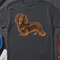 Long-haired brown dachshund illustration on a dark grey t-shirt.