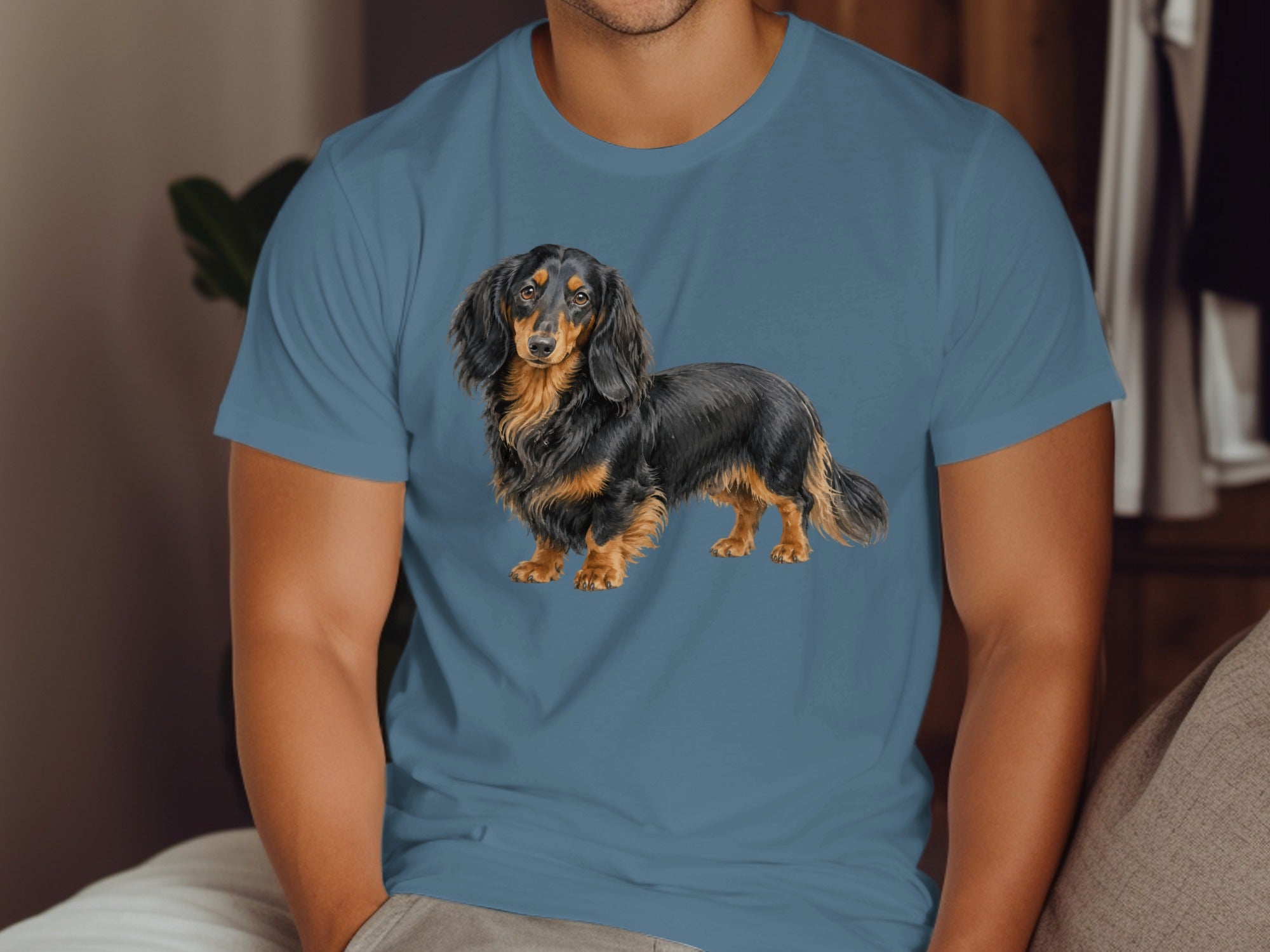 Long-haired black and tan dachshund illustration on a blue t-shirt.