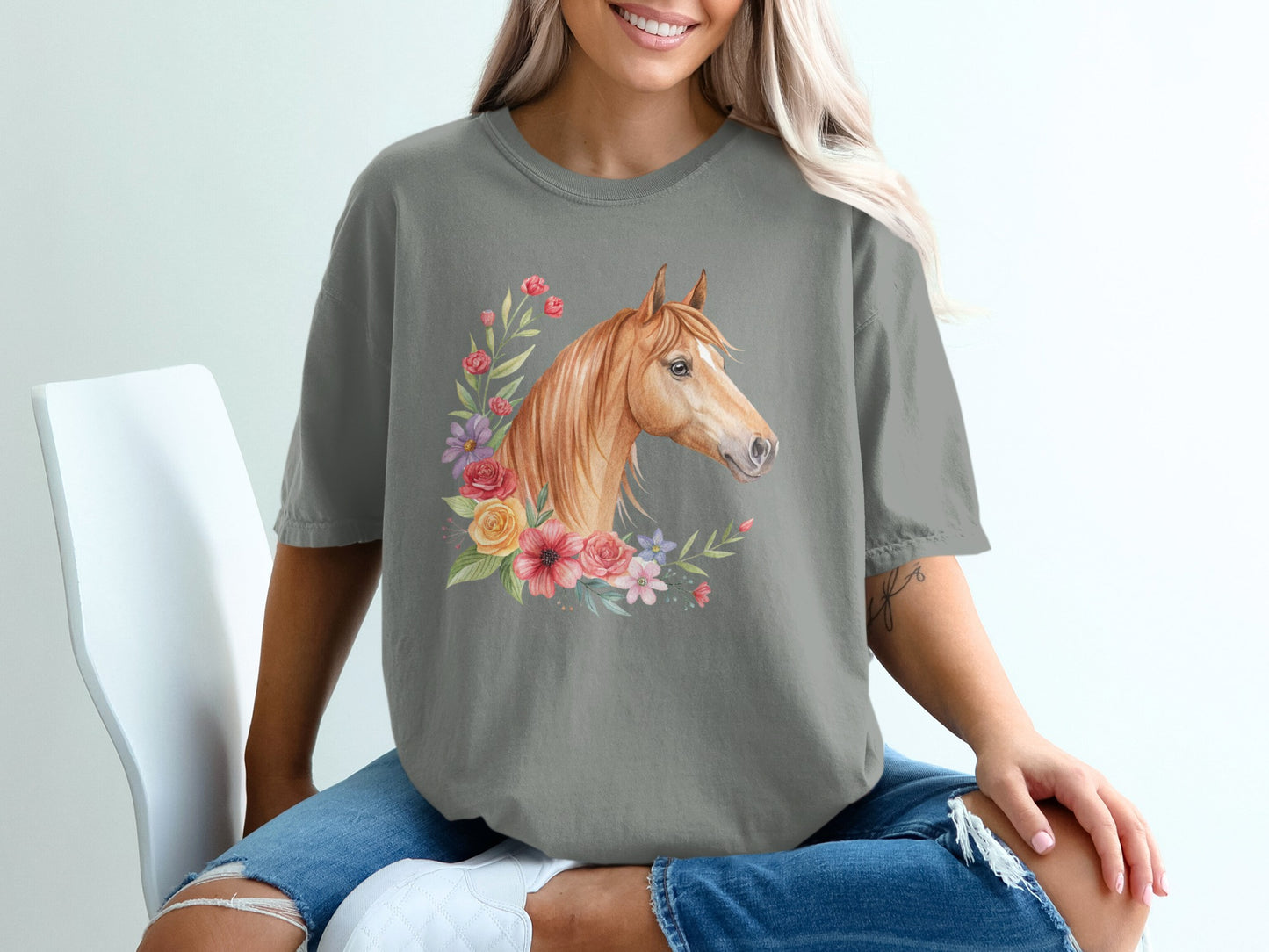Horse head with floral wreath on grey t-shirt.