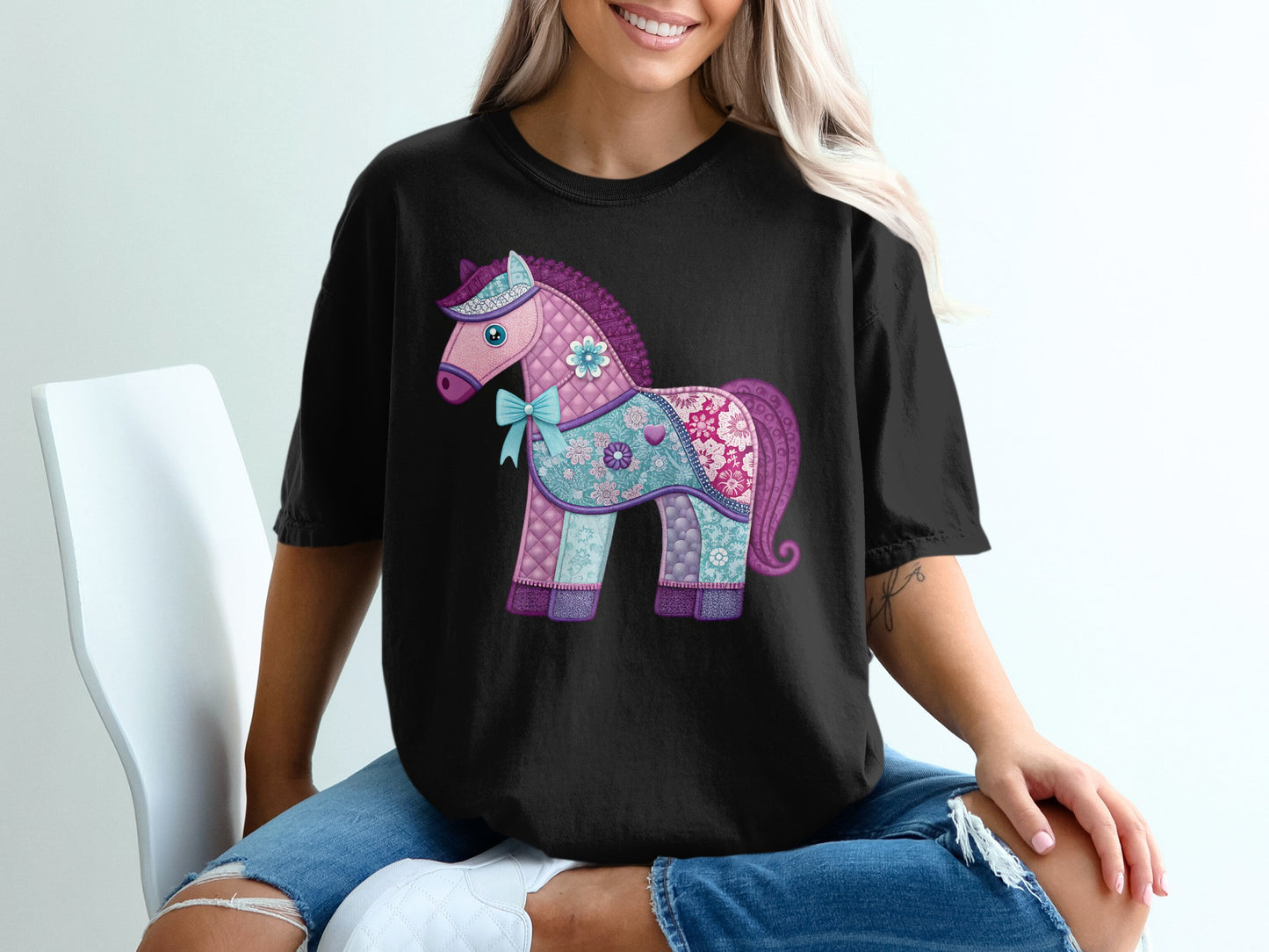 Black t-shirt with a quilted, colorful unicorn design.