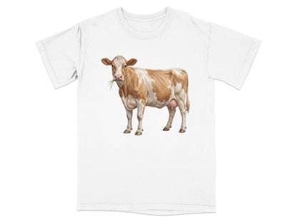 White t-shirt with a brown and white cow illustration eating grass.