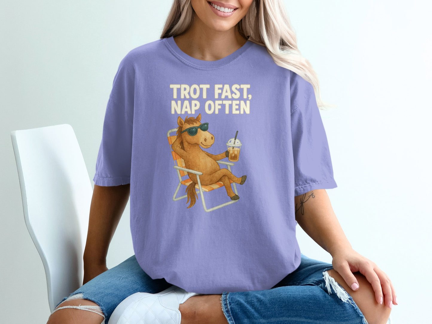 Purple t-shirt with "Trot Fast, Nap Often" text and a relaxed horse on a beach chair.