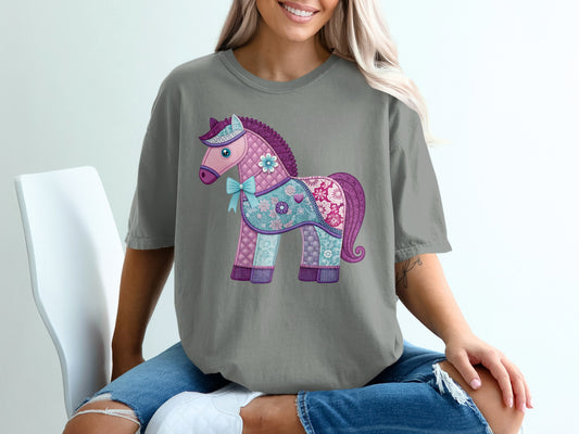 Grey t-shirt with a quilted purple and pink horse design.
