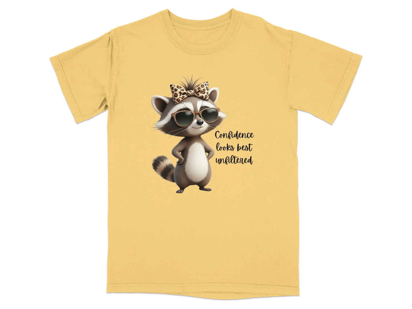 Yellow t-shirt with a cartoon raccoon wearing sunglasses and a bow, with text.