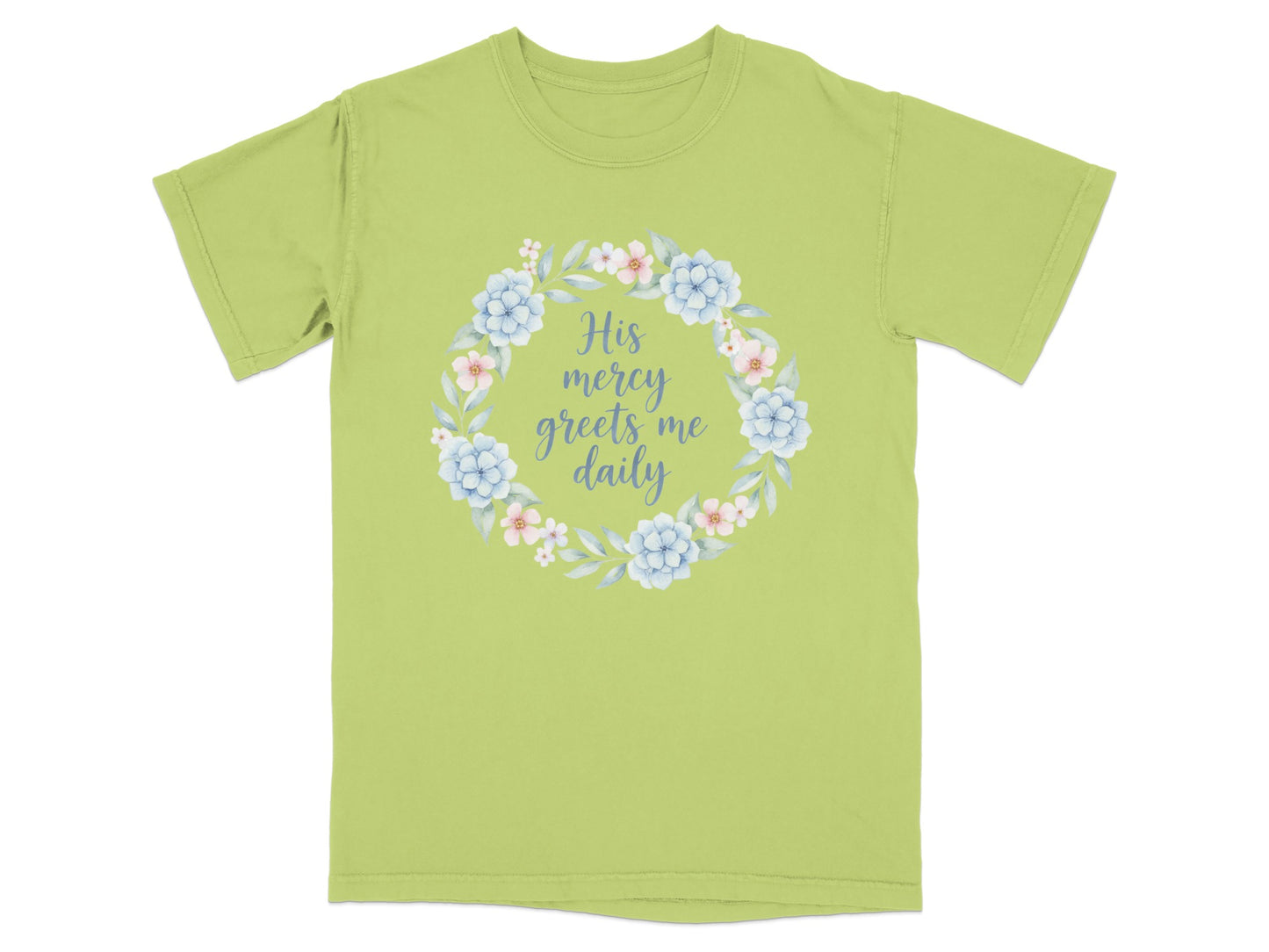 Light green t-shirt with floral wreath and "His mercy greets me daily" text.