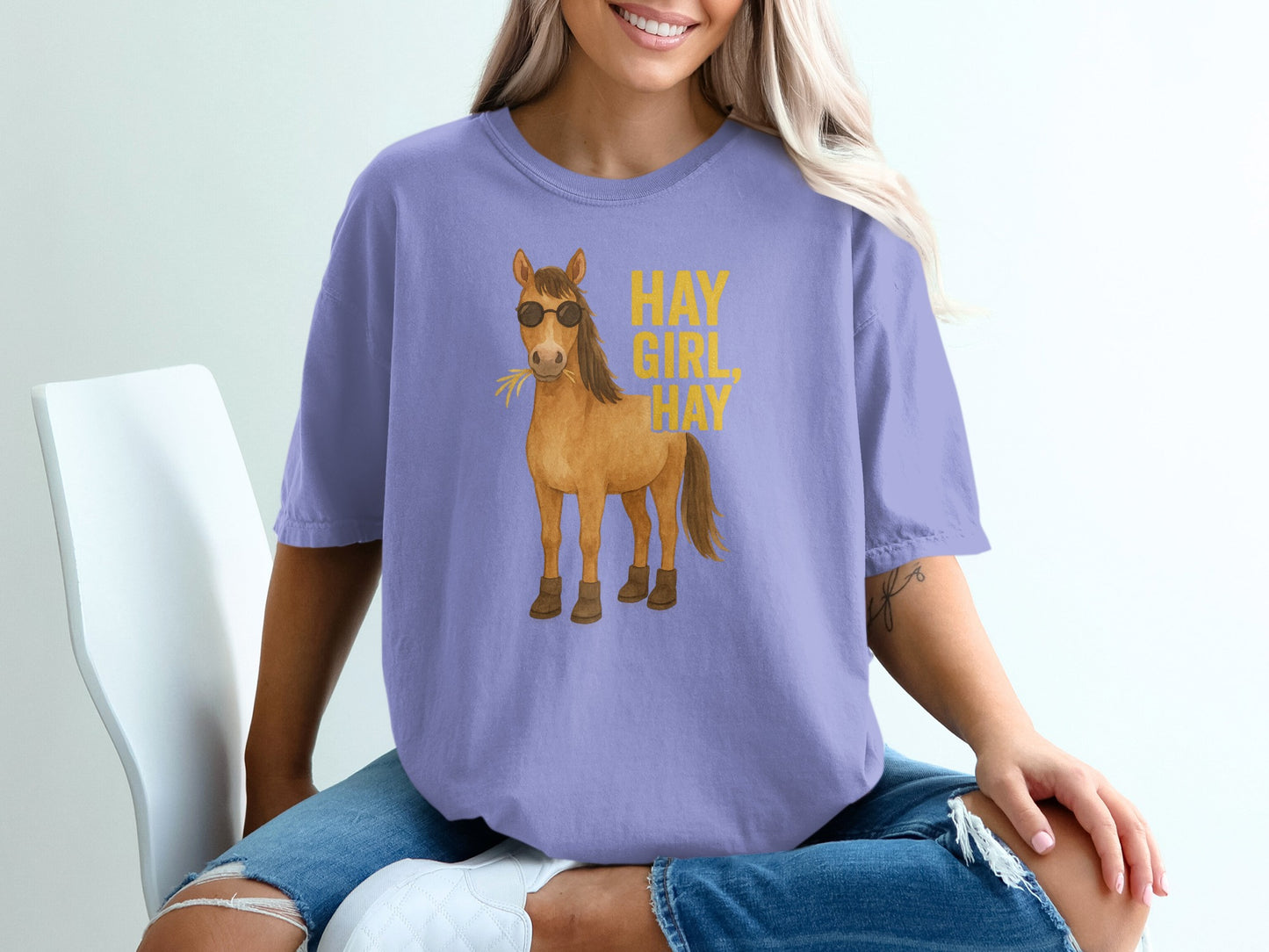 Lavender t-shirt with sunglasses-wearing cartoon horse and text "HAY GIRL HAY".