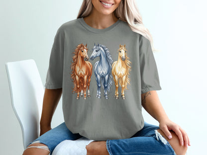 Three horses, one brown and two white, on a gray t-shirt.