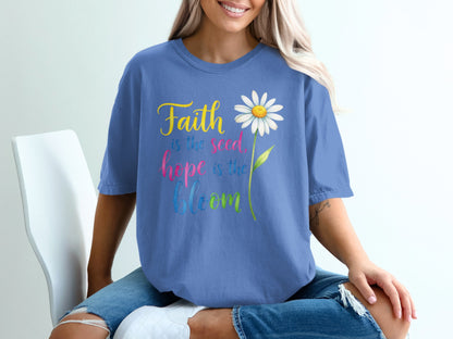 Blue t-shirt with "Faith is the seed, hope is the bloom" and a daisy.