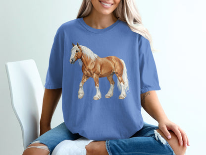 Light brown horse illustration on a blue t-shirt worn by a person.