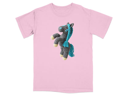 Pink t-shirt with a gray crocheted horse graphic with blue yarn mane and tail.