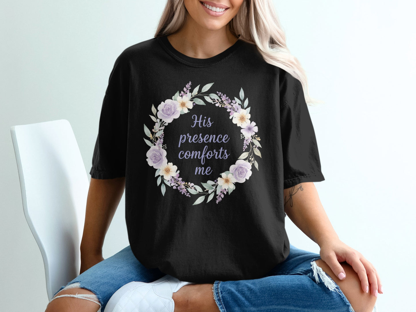 Black t-shirt with a floral wreath and text "His presence comforts me".