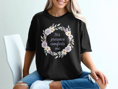 Black t-shirt with a floral wreath and text "His presence comforts me".
