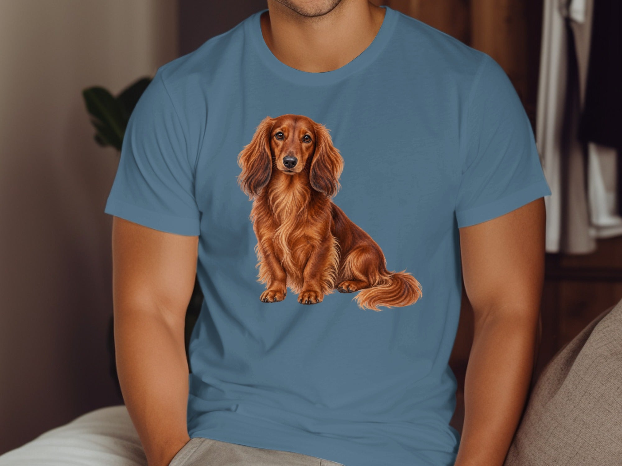Long-haired brown dachshund illustration on a blue t-shirt.